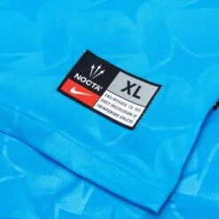 Nike X NOCTA Distant Regards Jersey - Blue Glow/White -Fashion Clothing Store Nike x Nocta Lu Home Jersey Top Blue Glow White DR2616 450 02 25 23 Feature KN 9